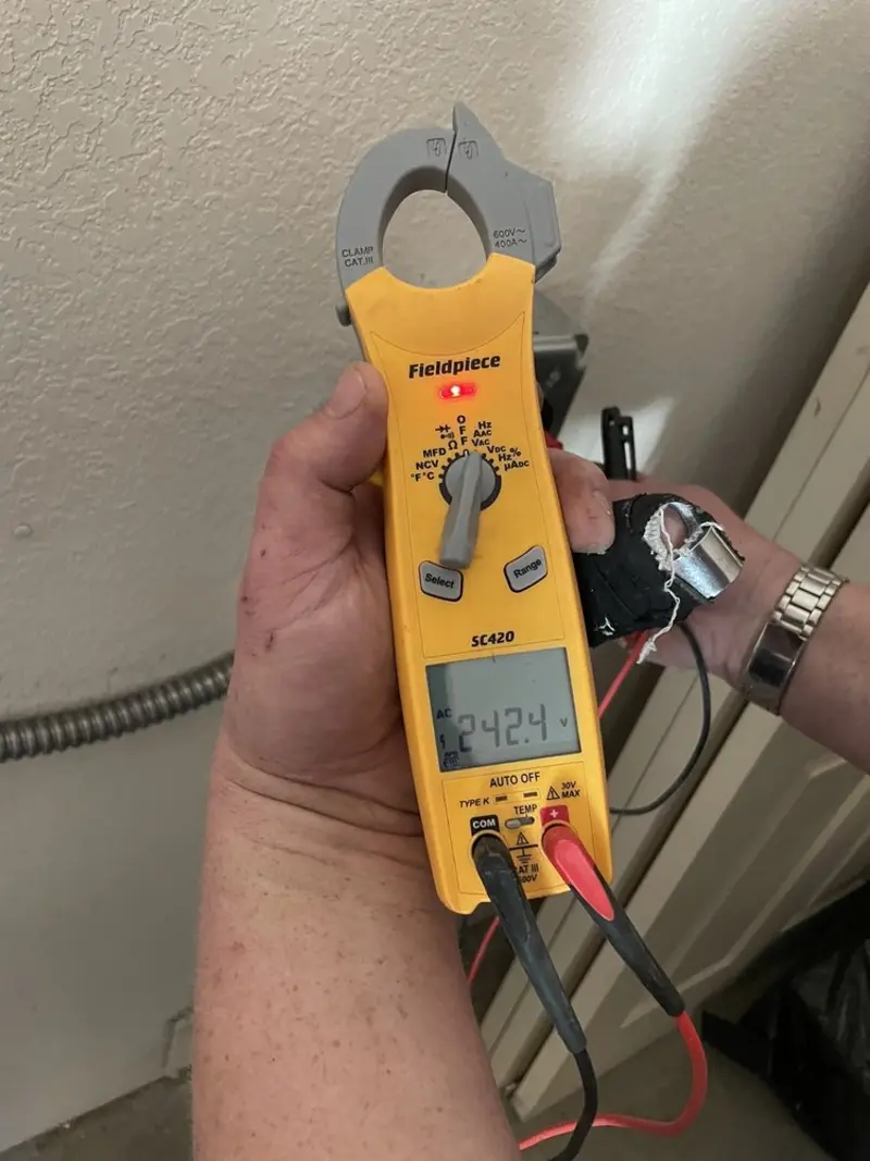 Voltage testing with clamp meter during Whole House Surge Protector in Orange